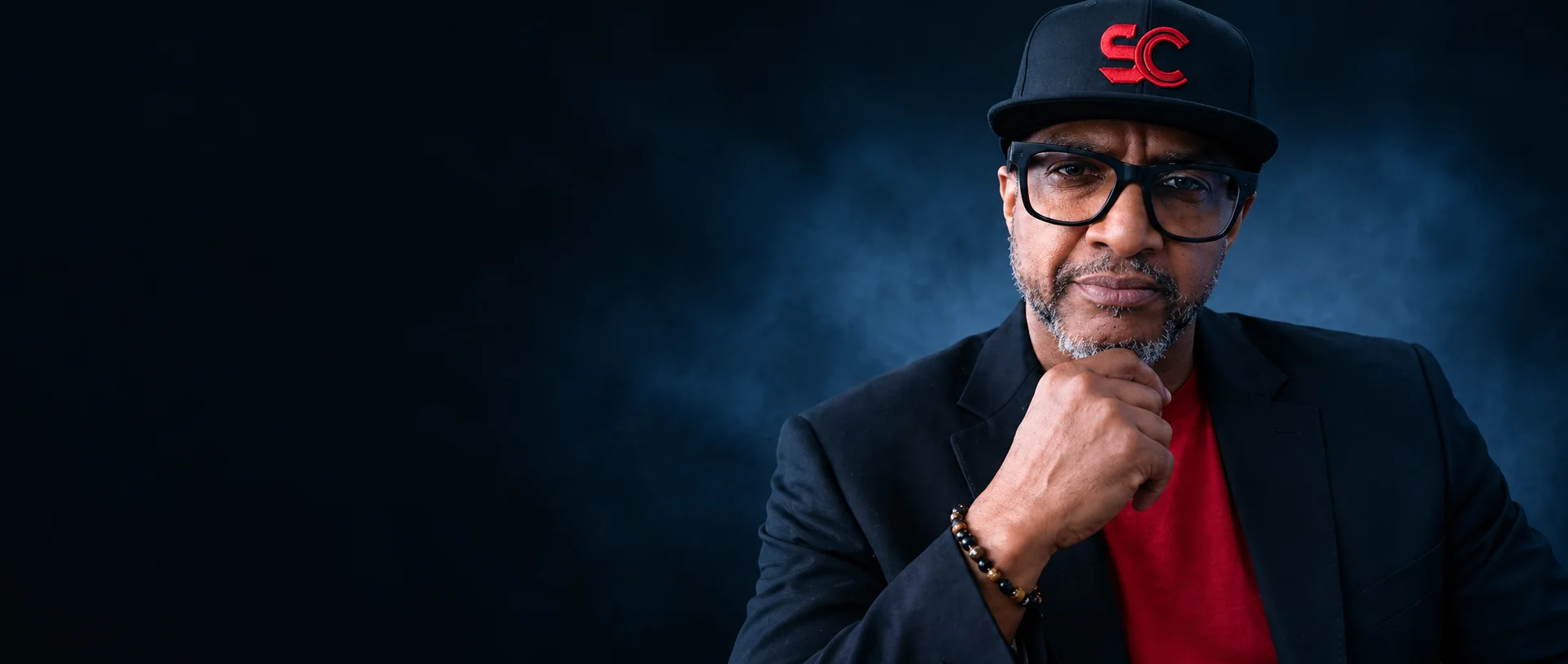 The Producer Whisperer in a black SMASHCOAST cap and jacket