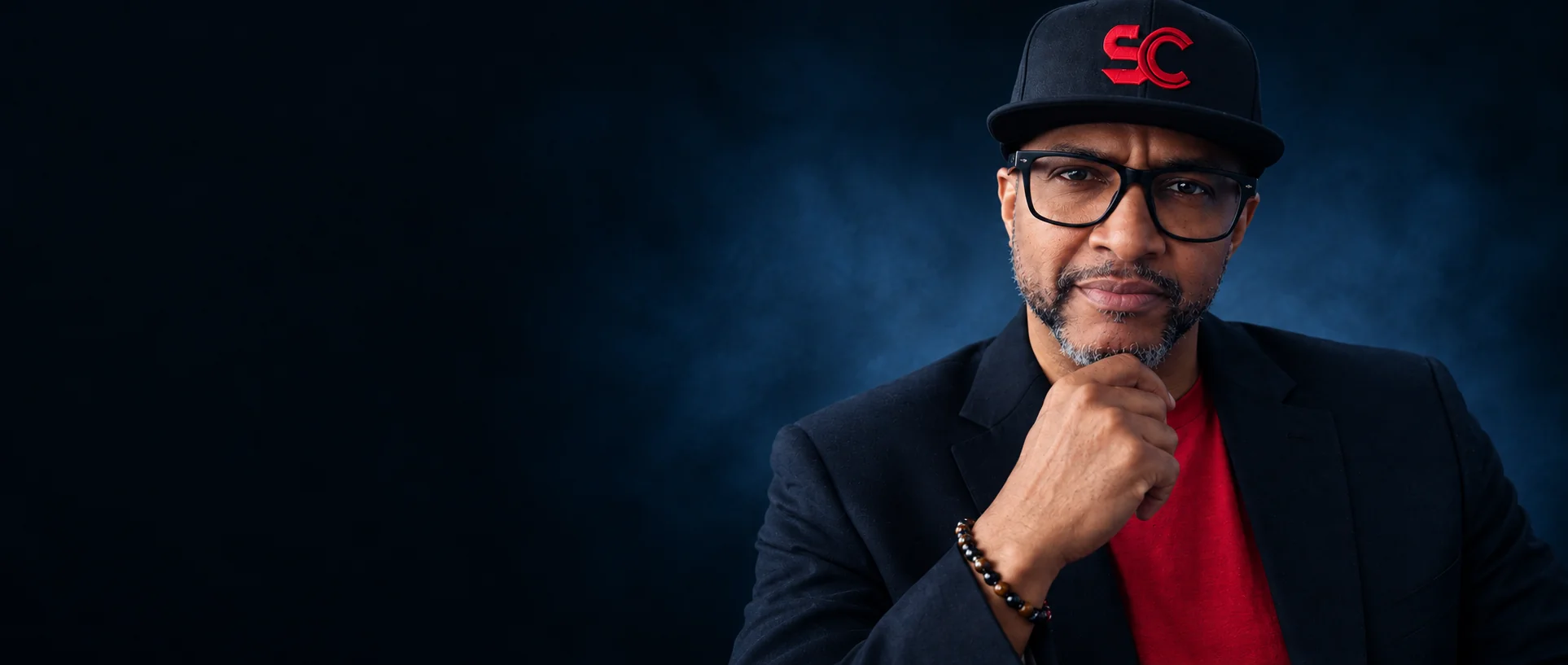 The Producer Whisperer in a black SMASHCOAST cap and jacket